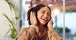 Happy woman, headphones and listening with music for audio streaming or online podcast on sofa at home. Young female person with smile in joy or dance for song, sound or radio on mobile smartphone