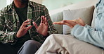 African couple, hands and conflict on sofa in home for disagreement, communication problem and relationship discussion. Man, woman and together with argument in house, emotional stress and dispute.