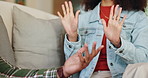 Couple, hands and conflict on couch in home for disagreement issue, communication problem and relationship discussion. Man, woman and together with argument in house, emotional stress and dispute.