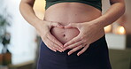 Woman, pregnant and heart hands in home for love, future and care for unborn baby. IVF healthcare, expecting mom or holding abdomen with pilates for wellness, healthy body or childcare in living room