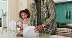 Father, daughter and washing dishes in home, hygiene and soap for disinfection in kitchen cleaning. Dad, girl and teaching child responsibility or support, bonding and sponge housework for plate dirt