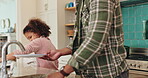 Father, daughter and washing dishes in home, routine and soap for disinfection in kitchen cleaning. Dad, girl and teaching child responsibility or support, bonding and sponge housework for plate dirt