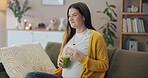 Detox, smoothie and wellness with pregnant woman on sofa in living room of home for prenatal health. Belly, drink and smile with happy mother of baby in apartment, thinking of future or maternity