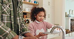 Father, daughter and washing plate in home, hygiene and soap for disinfection in kitchen cleaning. Dad, girl and teaching child responsibility or support, bonding and sponge housework to dry dishes