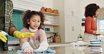 Father, girl and spray for cleaning kitchen together, hygiene and wipe counter for bacteria prevention. Dad, daughter and chemical detergent for maintenance support, mom washing dishes and helping