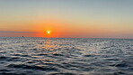 Horizon, water and waves at beach with sunset for travel location, tropical island and holiday destination. Aerial, ripples and tide in Tanzania for summer vacation, ocean scenery and sky environment