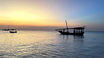 Sunset, ocean and yacht with silhouette of boat on outdoor travel adventure on island vacation seascape. Sky, sailing and water on tropical fishing holiday with calm sea, marine tourism and horizon