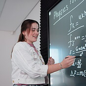 Female Tutoring Math Teaching, board and explaining of math, woman and writing of equations ...