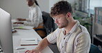 Computer, typing and man with glasses, office and copywriting with creativity, coworking and online. Digital, vision and writer with keyboard, research and proofreading of email for company or people