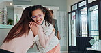Hug, child and people in optometry store for greeting, support and eye care in city. Young girl, sales assistant and hello in glasses shop for new lenses, consultation and vision development for kid