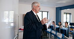 Mature man, teacher and students in whiteboard for information technology lesson in high school. People, professor and pupils in classroom for education, teaching and learning with knowledge