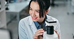 Scientist, woman and microscope with computer in laboratory for medical research or experiment results. Pathology study, happy professional and analysis of science discovery, disease cure and testing