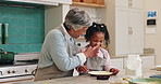 Baking, fun and granny teaching girl how to prepare dough or pastry in kitchen of home together. Child development, food or playful family with senior woman and grandchild in apartment for lesson