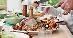 Cutting, knife and roast with hands of person at dining room table of home for thanksgiving feast. Carving, food and social gathering with poultry dish in apartment closeup for diet or hunger