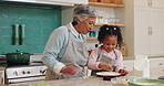 Baking, child development and granny teaching girl how to prepare dough or pastry in kitchen of home together. Cooking, family or food with senior woman and grandchild in apartment for bakery lesson