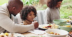 Father, boy and feeding outside for lunch on thanksgiving for celebration and love at home. People, family and smile or happy for visit with food on table in garden for unity, support and care