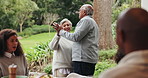 Senior, couple and dancing in garden at family reunion for celebration together with fun. Happy woman, outdoor and smile with holding hands, care and love in backyard at anniversary party and event