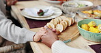 Holding hands, people and prayer with food for celebration with gratitude, spiritual hosting and respect of reunion. Family, praying and worship god for eating together, support and thanks at house