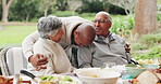 Mature parents, son and happy outside for lunch on thanksgiving for celebration and love at home. People, hug and smile or excited for visit with food on table in garden for unity, support and care