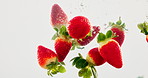 Strawberry, hydration and natural fruit with water splash for vitamin c, fresh produce or wash on a white background. Closeup of wet organic food, juicy or sweet nutrition for healthy diet or fiber