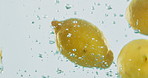 Fruit, lemon and vitamin c with water splash for natural nutrition, fresh produce or hydration in studio on a white background. Closeup of juicy, citric acid or wet organic food for healthy diet