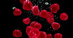 Red berries, water and hydration with natural fruit for vitamin c, fresh produce or wash on a black background. Closeup of organic food, juicy or sweet nutrition with splash for healthy diet or fiber