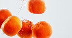 Fruit, orange and vitamin c with water splash for nutrition, fresh produce or hydration in studio on a white background. Closeup of juicy, citric acid or wet natural organic food for healthy diet