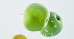 Fruit, water and mix with vitamin c for fresh produce, hydration or wash on a black background. Closeup of juicy, natural organic food or citric acid in wet splash for healthy diet or nutrition