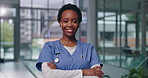 Portrait, black woman and happy nurse with arms crossed for healthcare service, job or pride. Face, confidence and African medical surgeon laugh, worker and employee with expert experience in clinic