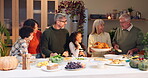 Happy family, kitchen and dinner for thanksgiving in home with love, food and gratitude for holiday celebration. Kids, conversation and table with care or embrace, feast and reunion with relatives.