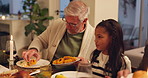 Thanksgiving, girl and mature man with food for dishing, family dinner and hearty meal at home. Grandpa, child and traditional celebration in dining room for nutrition, serving and holiday enjoyment