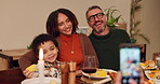 Food, photograph and smile with family at dining room table of home together for thanksgiving celebration. Bonding, love or memory with mother, father and son taking picture in apartment at night