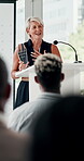 Executive woman, podium and speech with award for announcement, offer or thank you to team at seminar. Mature female person, CEO or speaker talking to crowd in meeting to announce winner or promotion