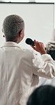 Woman, microphone and crowd at conference for business, back and questions for speaker for training. Person, employee and audio for voice, opinion and discussion at tradeshow, workshop or convention