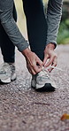 Hiking, mature hands and tie sneakers on road to start running, workout or training. Senior woman, wellness and tying shoe laces or footwear to prepare or ready for exercising or cardio outdoors