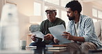 Senior father, man and documents with talking for helping, advice and explaining with financial statement. Home, dad and male advisor in sofa with paperwork, retirement plan and investment records