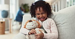 Teddy bear, happy and face of child on sofa with cute toy for playing, relaxing and embrace in home. Family, smile and portrait of young girl with toy for cuddle, childhood and joy in living room