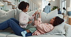 Relax, playing and mother with child on sofa in living room for bonding, love or connection. Happy, rest and mom laying on couch with girl kid having fun together for family time in lounge at home.