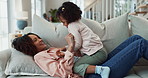 Tickle, happy and mom with kid on sofa for bonding, playing and relax together in living room. Family, home and silly mother and young girl having fun for laughing, goofy relationship and affection