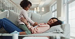 Tickle, happy and mom with girl on sofa for bonding, playing and relax together in living room. Family, home and silly mother and child having fun for laughing, goofy relationship and affection