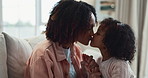 Mother, girl and kiss in home for comfort, love and affection for support in bonding. Mom, daughter and holding hands for connection in embrace, talk and kid for security in relationship to relax