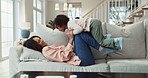 Laugh, playing and mom with kid on sofa for bonding, love and playful relationship in living room. Family home, childhood and mother with young girl for flying, fun and relax on weekend together