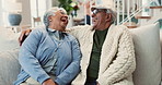 Senior couple, together and laugh on sofa for funny conversation, bonding and love hug in home. Elderly man, woman and happy on couch with silly discussion for comedy joke, embrace and retirement