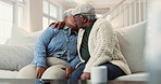 Senior, couple and kiss on couch with love for marriage, commitment and romance in retirement. Elderly, people and embrace in home with laughing, happy and talking in living room for bonding or relax