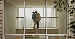 Senior couple, dancing and love in home with bonding, together and moving with connection in retirement. Elderly man, woman and holding hands with steps by window with kiss at house in Colombia