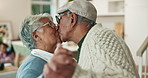 Senior couple, kiss and dancing with love for support, respect and bonding together for loyalty. Old people, connection and happy dance in family home for retirement, relationship trust and energy