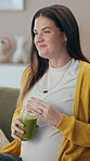 Pregnant woman, drinking juice and relax in home, nutrition and prenatal vitamin for immune system. Female person, green smoothie and thinking on maternity care, contemplating and glass of minerals