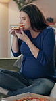 Pregnancy, eating and woman with pizza in home relaxing with fast food dinner, meal or supper. Hungry, prenatal care and pregnant female person enjoying takeaway in living room for lunch at house.