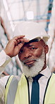 Engineer, face and warehouse for inspection, quality control and maintenance as supervisor with helmet. Mature, African man and portrait in logistics, industry and freight management for supply chain