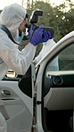 Forensic, photographer and car evidence at crime scene for investigation with hazmat, accident and teamwork. Csi, man and photography of vehicle for research, observation and case analysis of murder